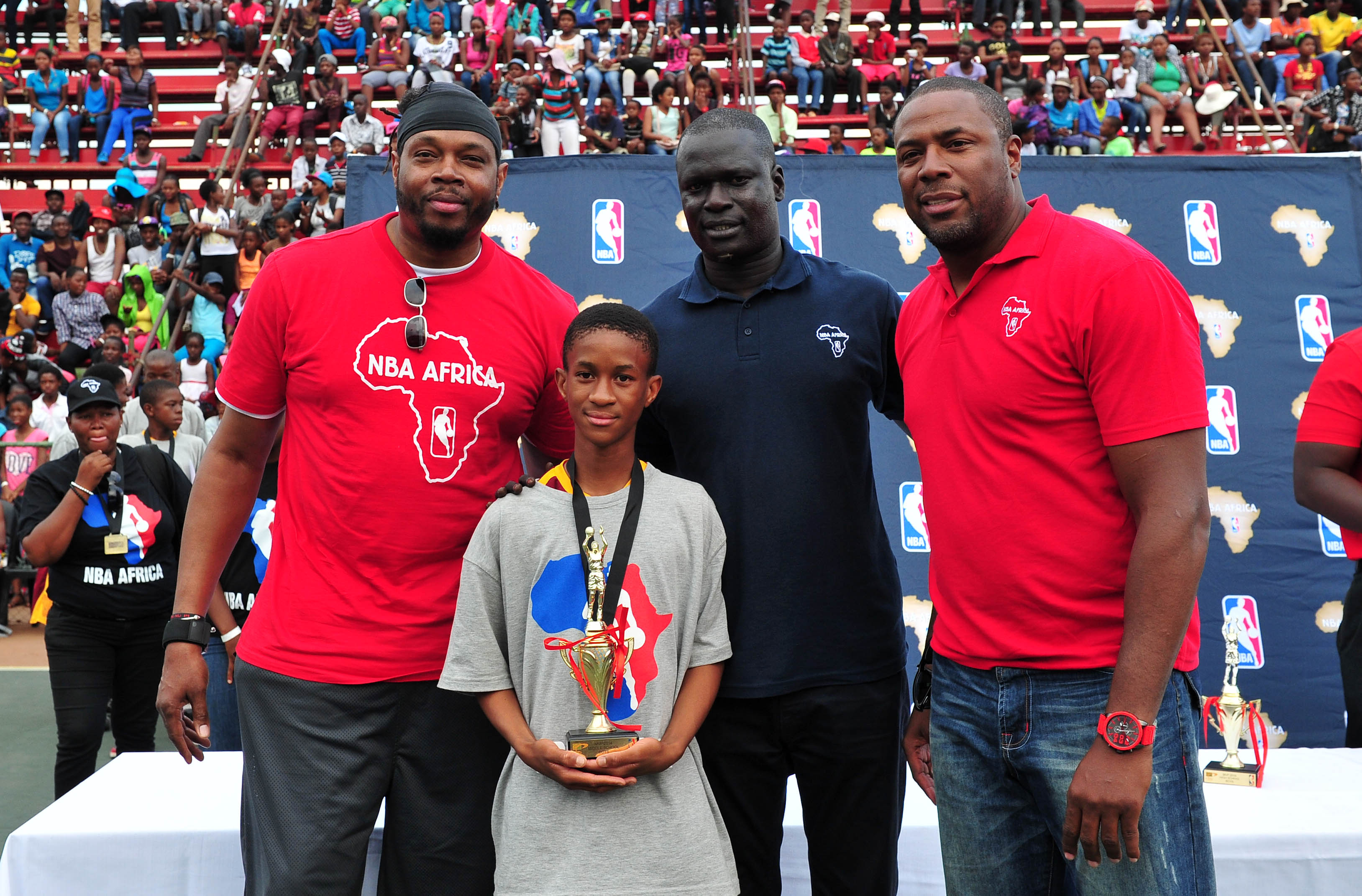 Most Valuable Player of the boys Middle School: Kamogelo Marumo with NBA Legends: Sam Perkins , Cedric Ceballos and NBA Vice President Amadou Fall, 25 October 2014